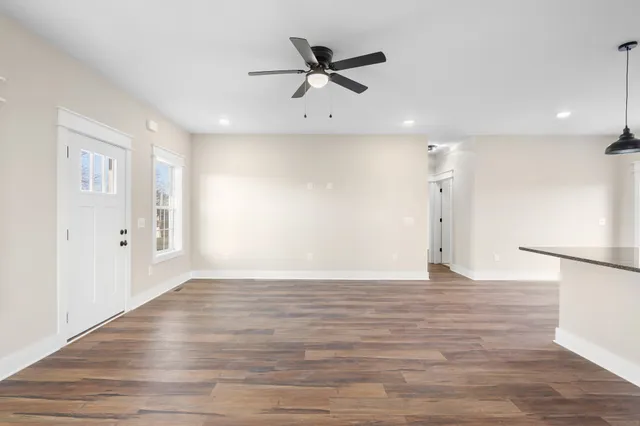 a kitchen with stainless steel appliances granite countertop a sink a stove and cabinets