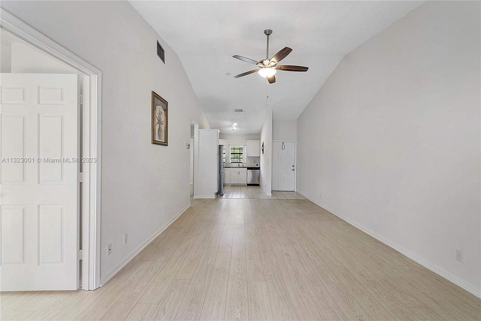 3000 Norwood Place, Unit N202 Boca Raton, FL 33431 - Photo 12 of 26 a view of a livingroom with a chandelier fan and windows