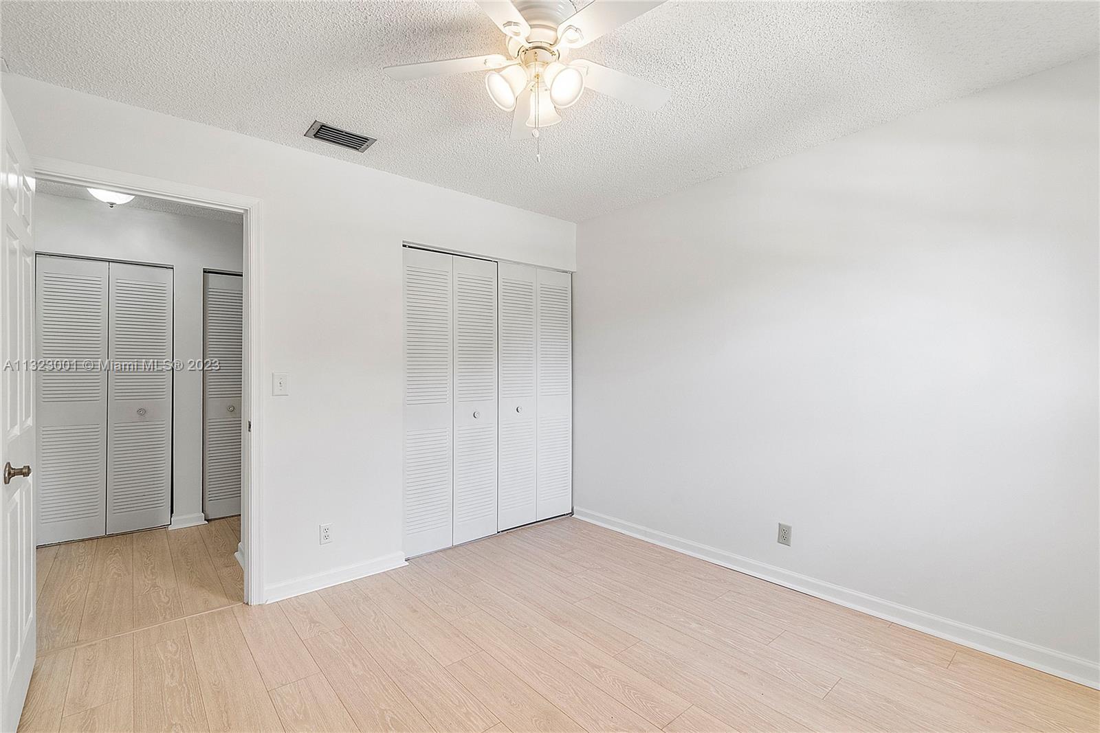 3000 Norwood Place, Unit N202 Boca Raton, FL 33431 - Photo 17 of 26 a view of a room with a ceiling fan and a window