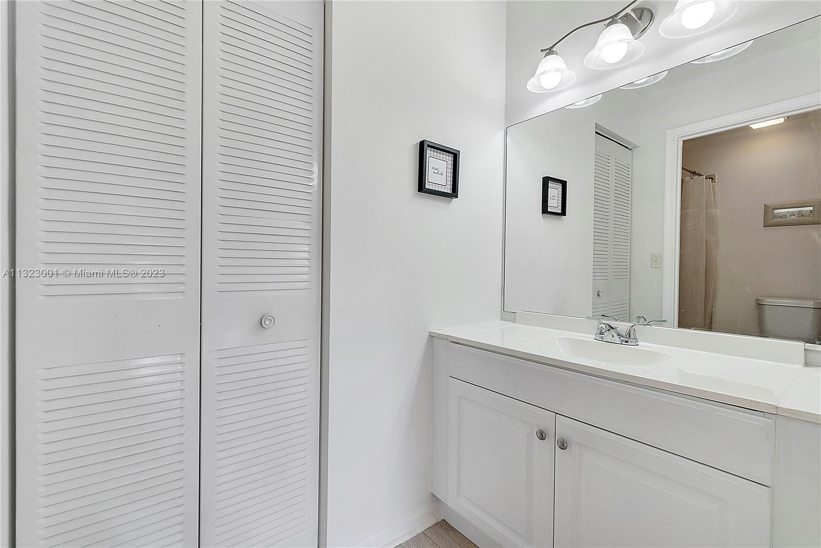 3000 Norwood Place, Unit N202 Boca Raton, FL 33431 - Photo 21 of 26 a bathroom with a sink and a mirror