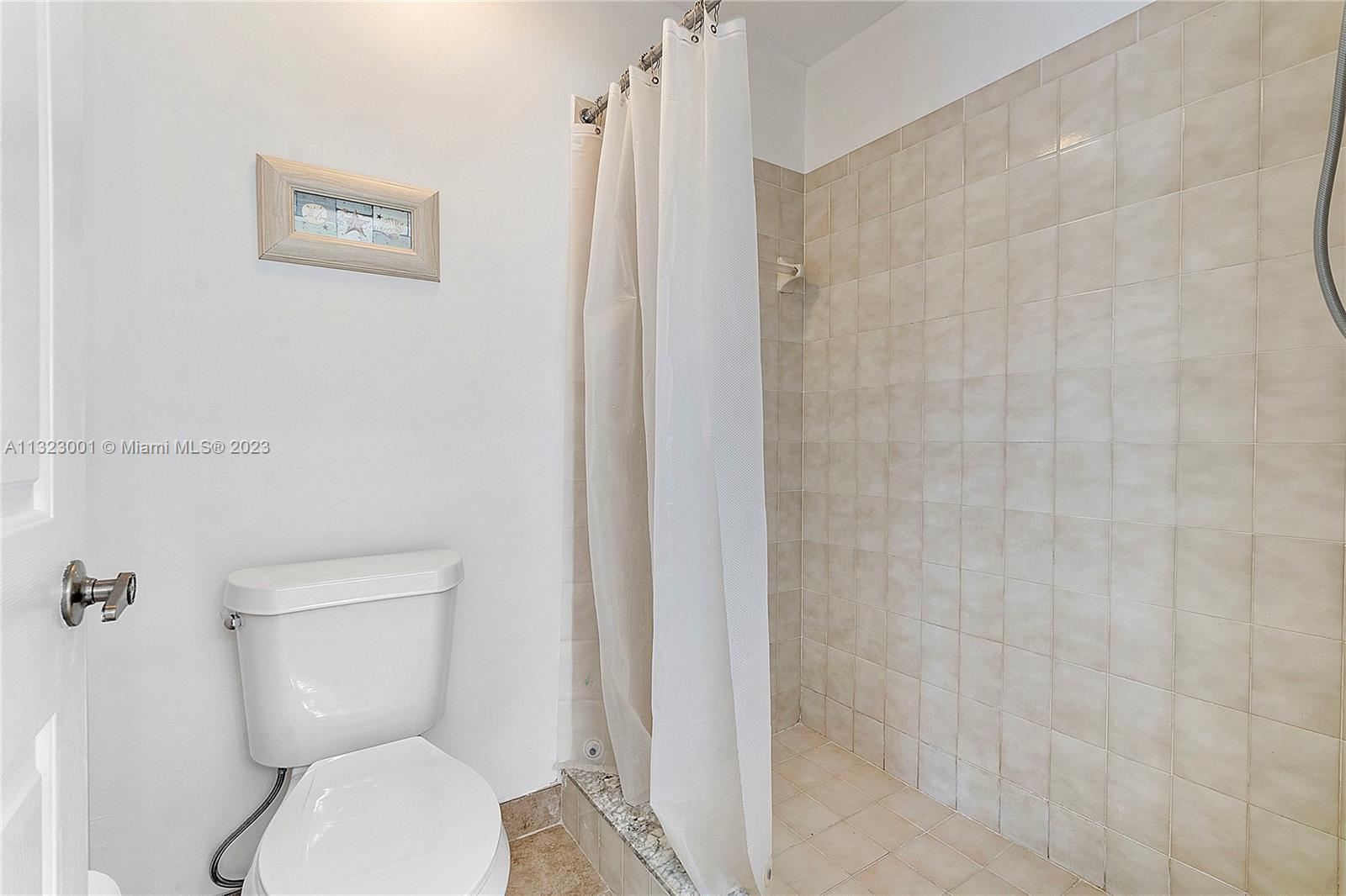 3000 Norwood Place, Unit N202 Boca Raton, FL 33431 - Photo 22 of 26 a white toilet sitting next to a shower