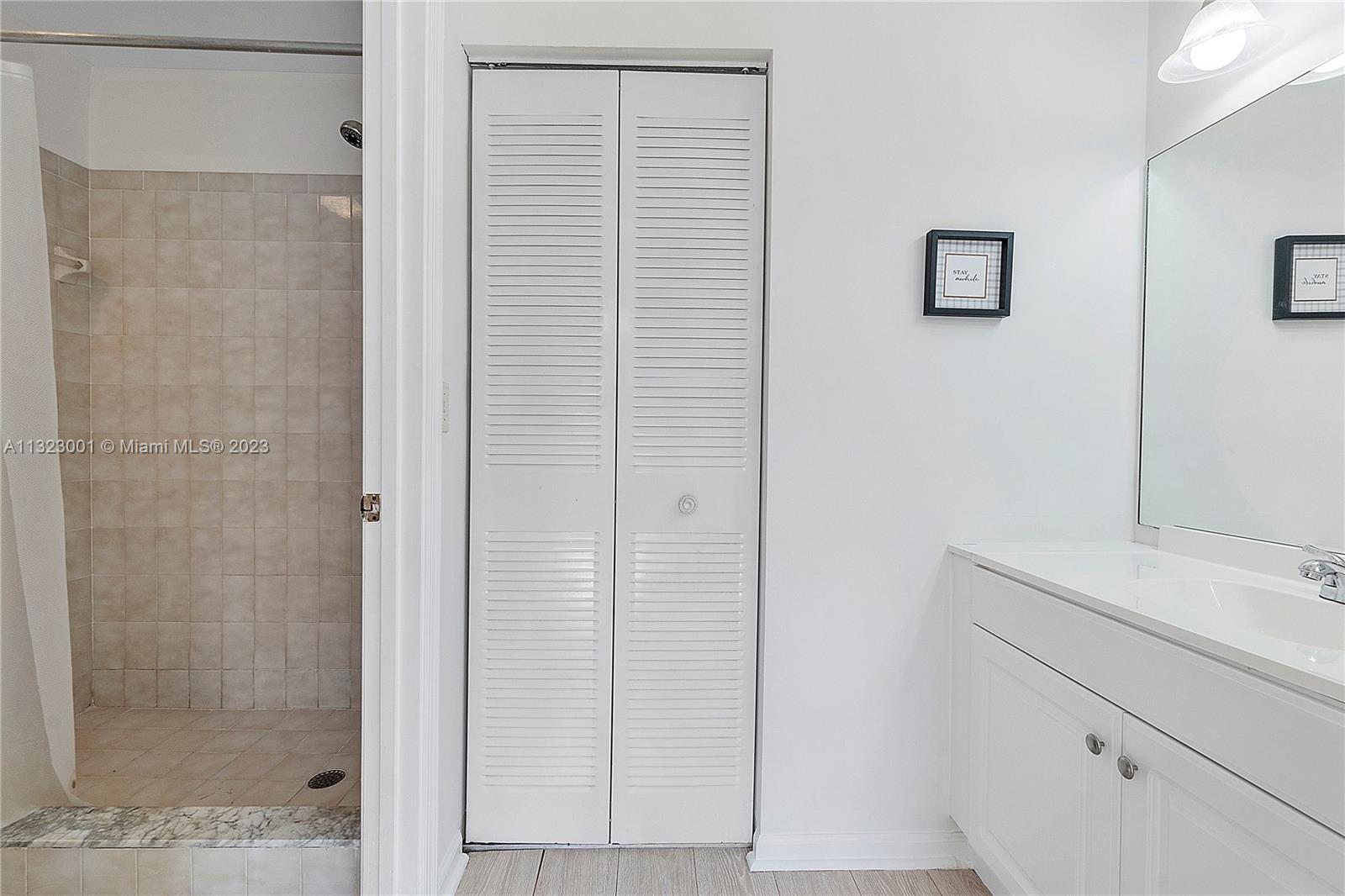 3000 Norwood Place, Unit N202 Boca Raton, FL 33431 - Photo 23 of 26 a bathroom with a shower and a sink