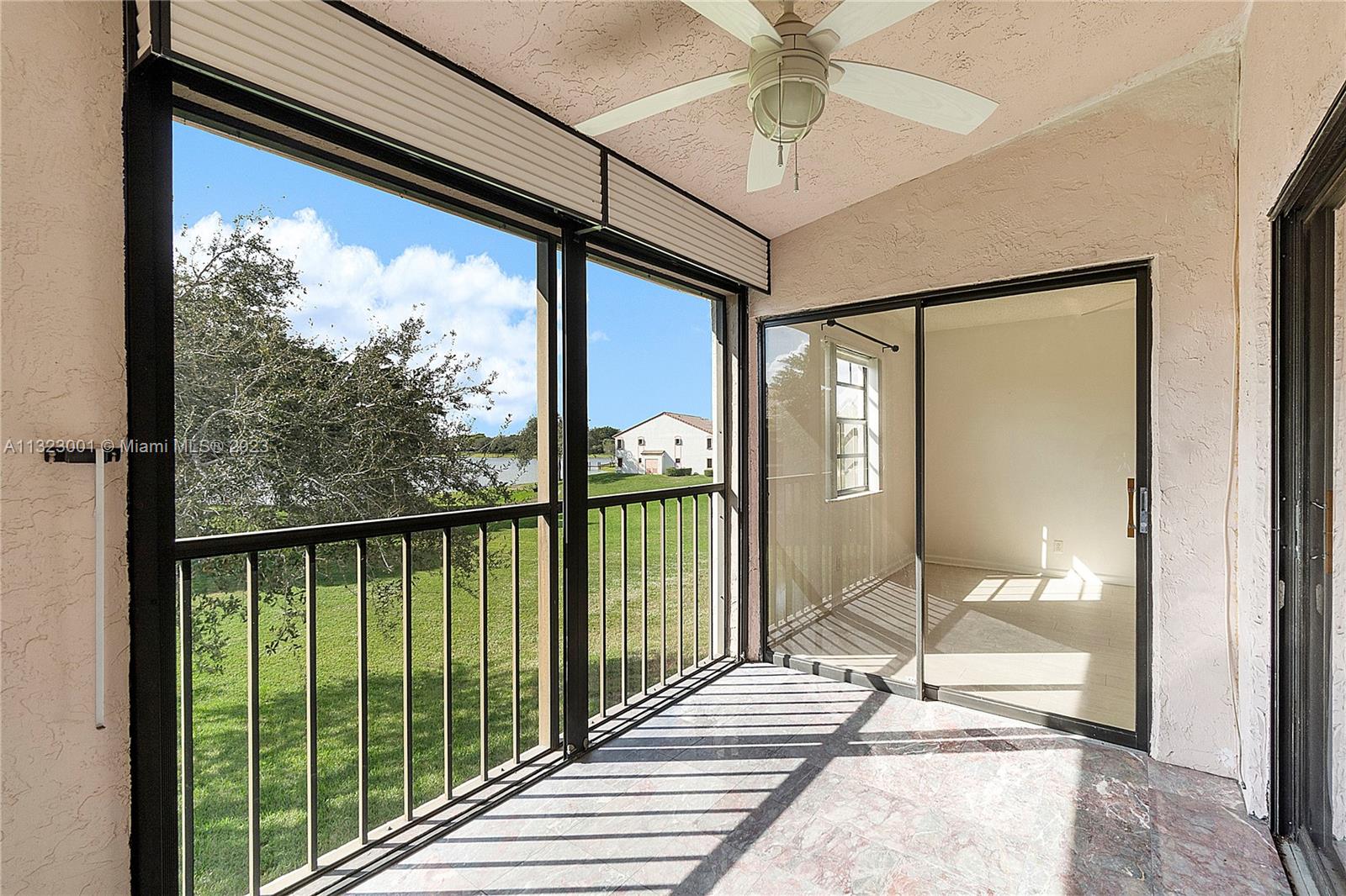3000 Norwood Place, Unit N202 Boca Raton, FL 33431 - Photo 25 of 26 a view of a balcony with a floor to ceiling window