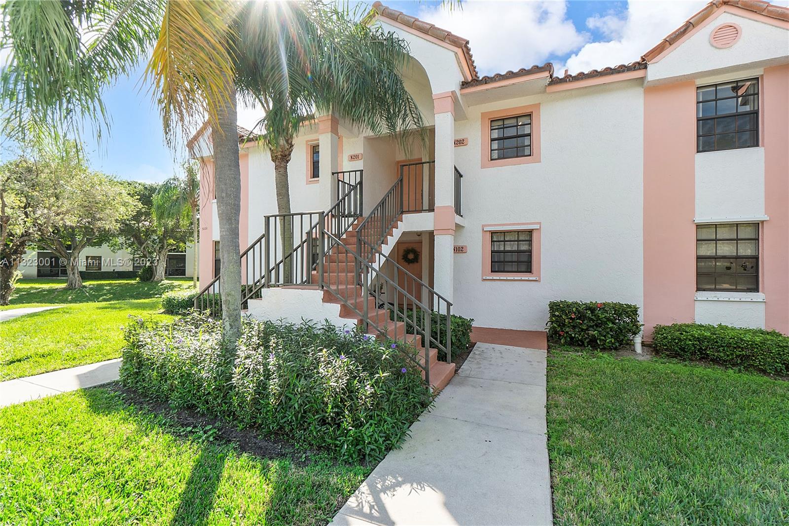 3000 Norwood Place, Unit N202 Boca Raton, FL 33431 - Photo 5 of 26 a front view of house with yard and green space