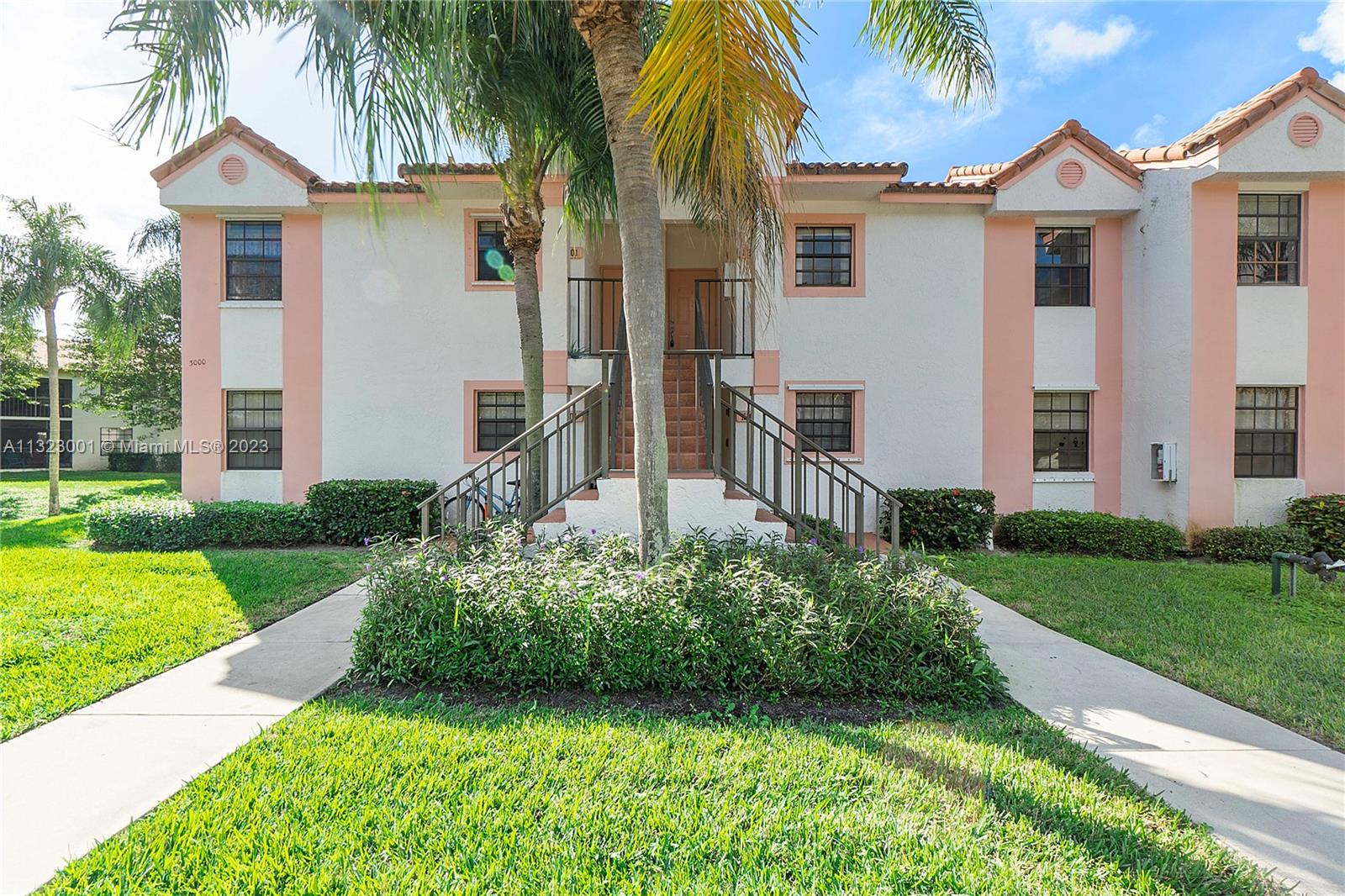3000 Norwood Place, Unit N202 Boca Raton, FL 33431 - Photo 6 of 26 a front view of a house with a yard