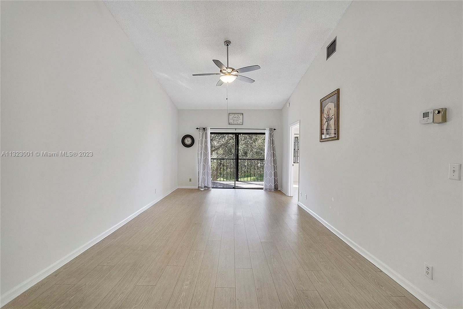 3000 Norwood Place, Unit N202 Boca Raton, FL 33431 - Photo 9 of 26 wooden floor in an empty room with a window