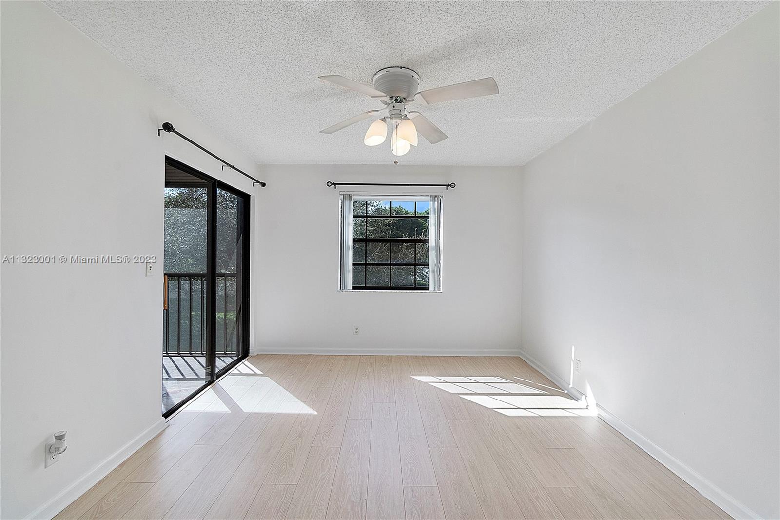 3000 Norwood Place, Unit N202 Boca Raton, FL 33431 - Photo 10 of 26 wooden floor in an empty room with a window