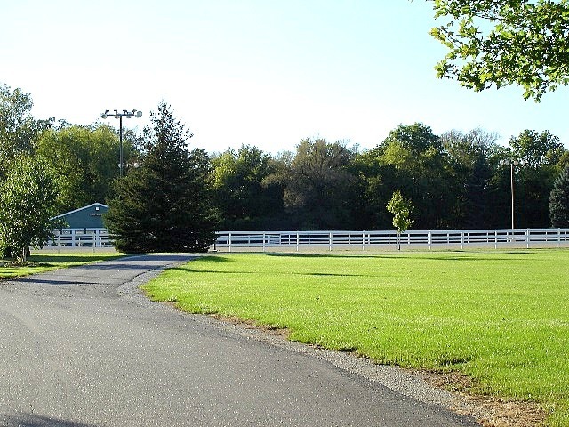 3012 Rolling Oaks Road Spring Grove, IL 60081 - Photo 7 of 9 a view of a swimming pool with a yard and trees