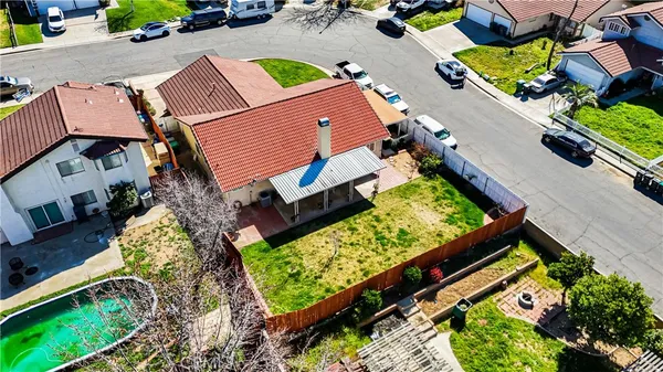 an aerial view of a house with a yard and lake view
