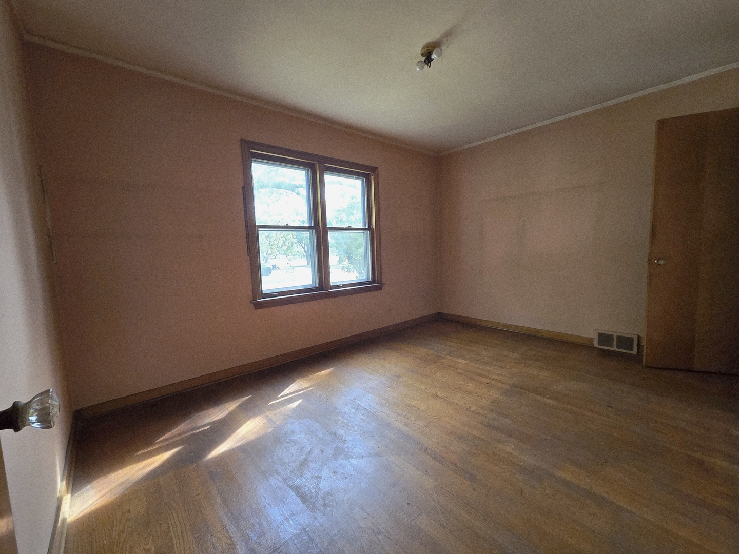 7742 South Oketo Avenue Bridgeview, IL 60455 - Photo 11 of 14 an empty room with wooden floor and windows