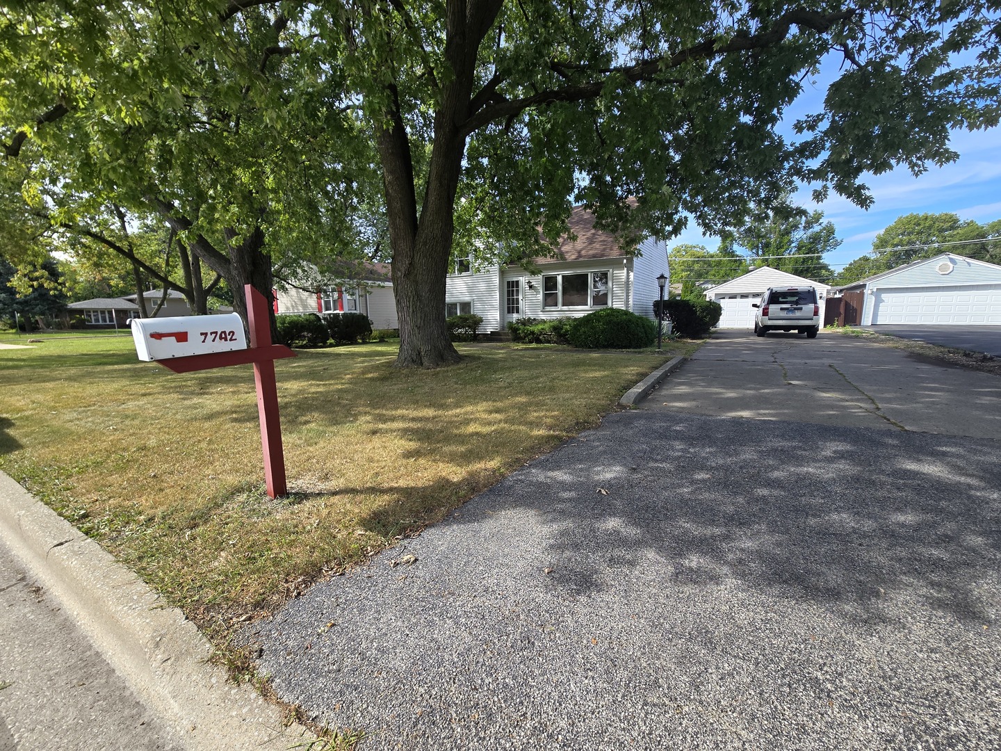 7742 South Oketo Avenue Bridgeview, IL 60455 - Photo 3 of 14 a front view of a house with a yard and garage