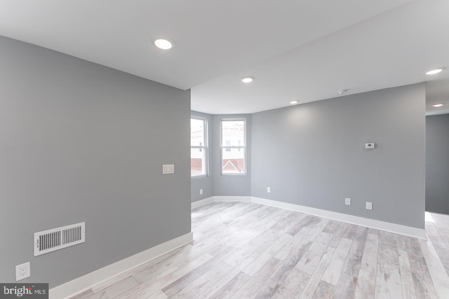 3252 Miller Street, Unit 2 Philadelphia, PA 19134 - Photo 13 of 16 a view of an empty room with wooden floor and a window