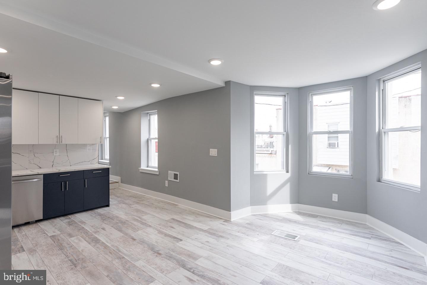 3252 Miller Street, Unit 2 Philadelphia, PA 19134 - Photo 8 of 16 a view of an empty room with window and wooden floor
