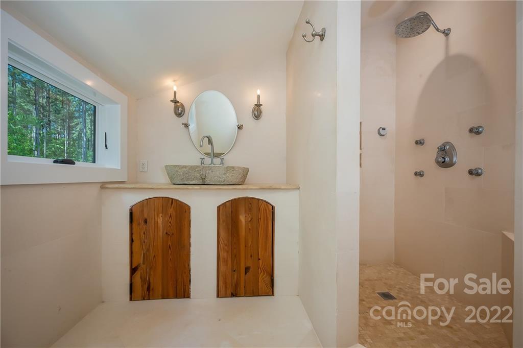 20 Hawk Ridge Drive Mill Spring, NC 28756 - Photo 18 of 48 a bathroom with a mirror and a sink