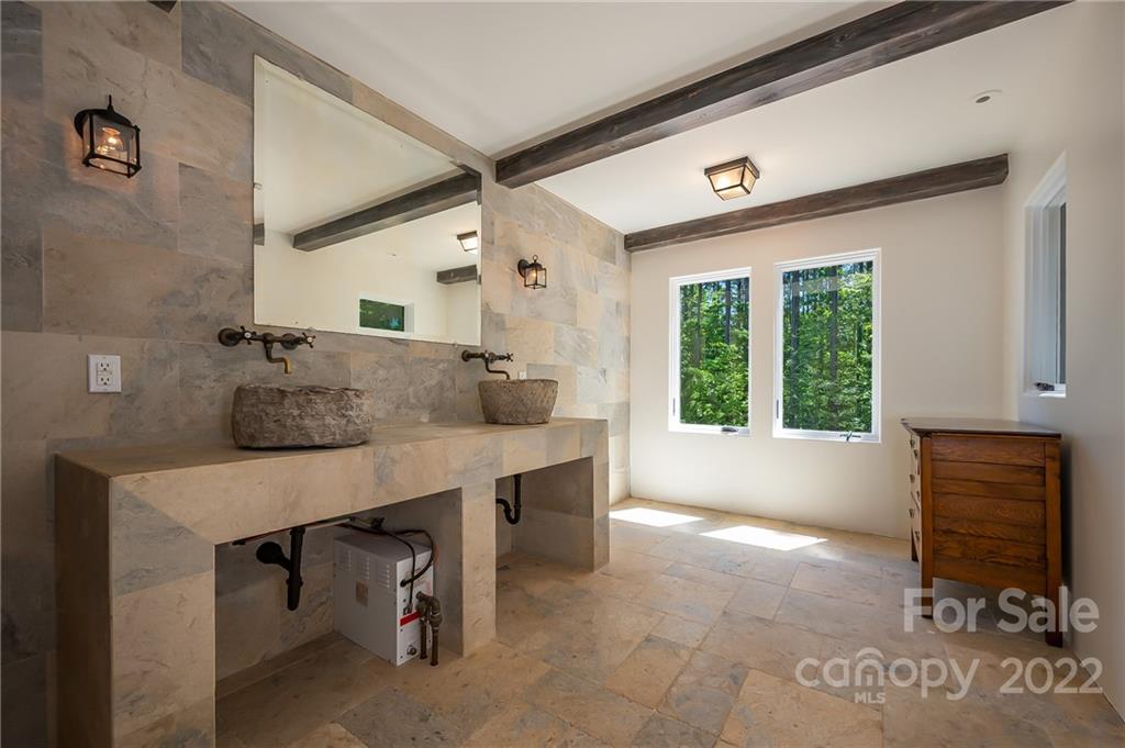 20 Hawk Ridge Drive Mill Spring, NC 28756 - Photo 43 of 48 a spacious bathroom with a sink a mirror and bathtub