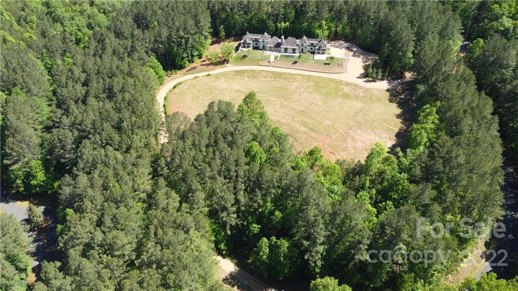 20 Hawk Ridge Drive Mill Spring, NC 28756 - Photo 5 of 48 a view of a swimming pool with a yard and large trees