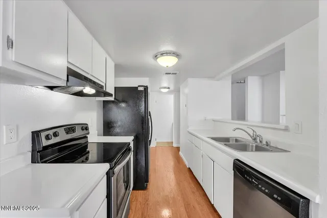 a kitchen with granite countertop a sink and stainless steel appliances