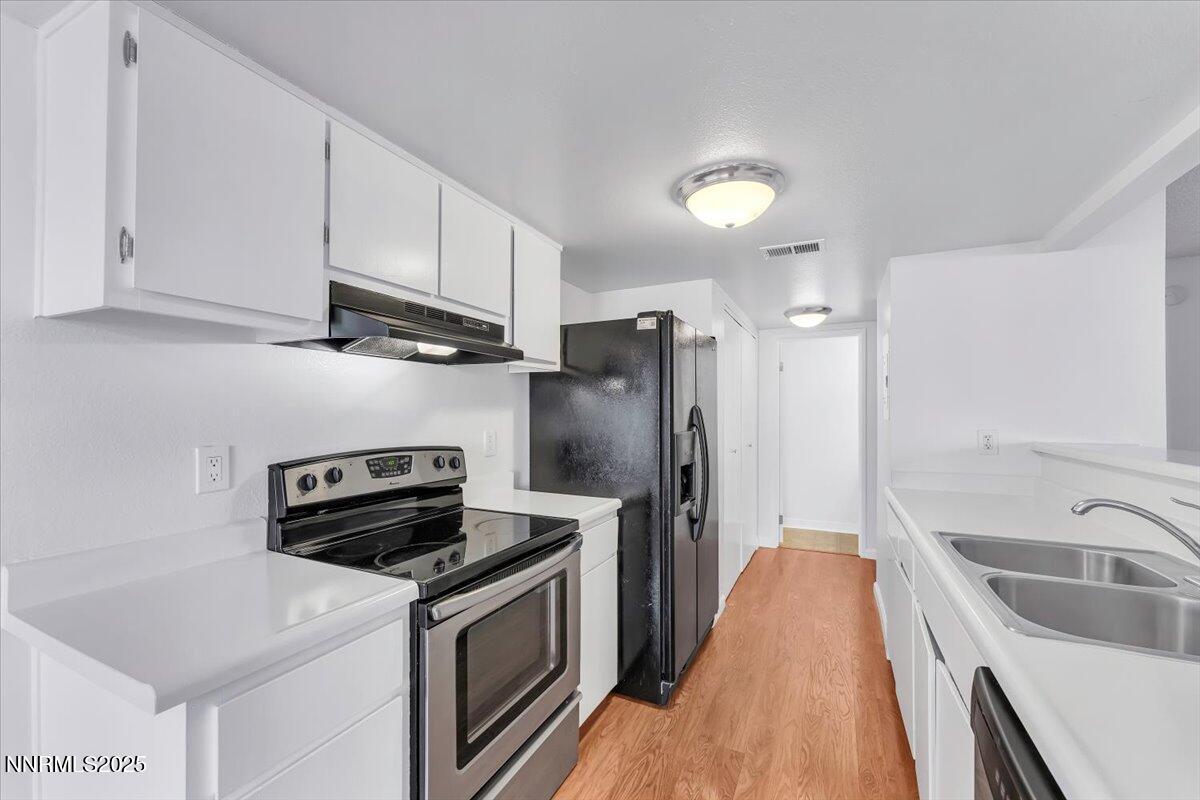 3230 Wedekind Road, Unit 64 Sparks, NV 89431 - Photo 12 of 28 a kitchen with stainless steel appliances a stove a sink a refrigerator and cabinets