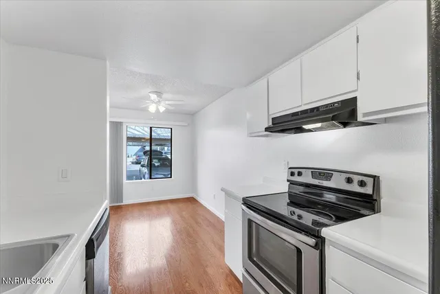 a kitchen with granite countertop a stove and a sink