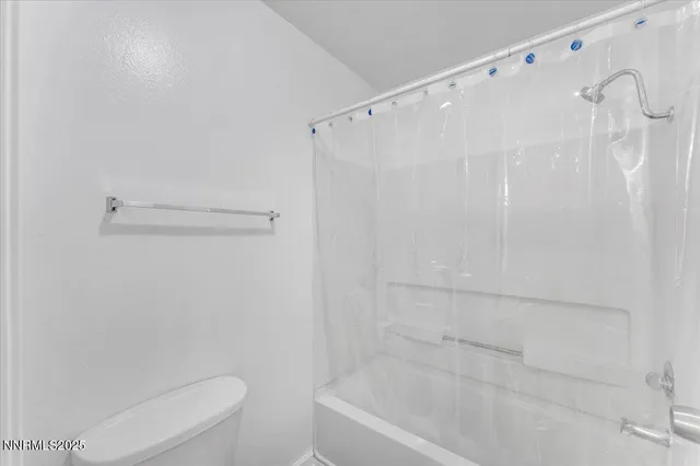 a bathroom with a shower and a toilet