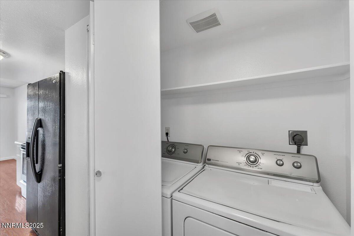 3230 Wedekind Road, Unit 64 Sparks, NV 89431 - Photo 24 of 28 a view of washer and dryer with kitchen in the background