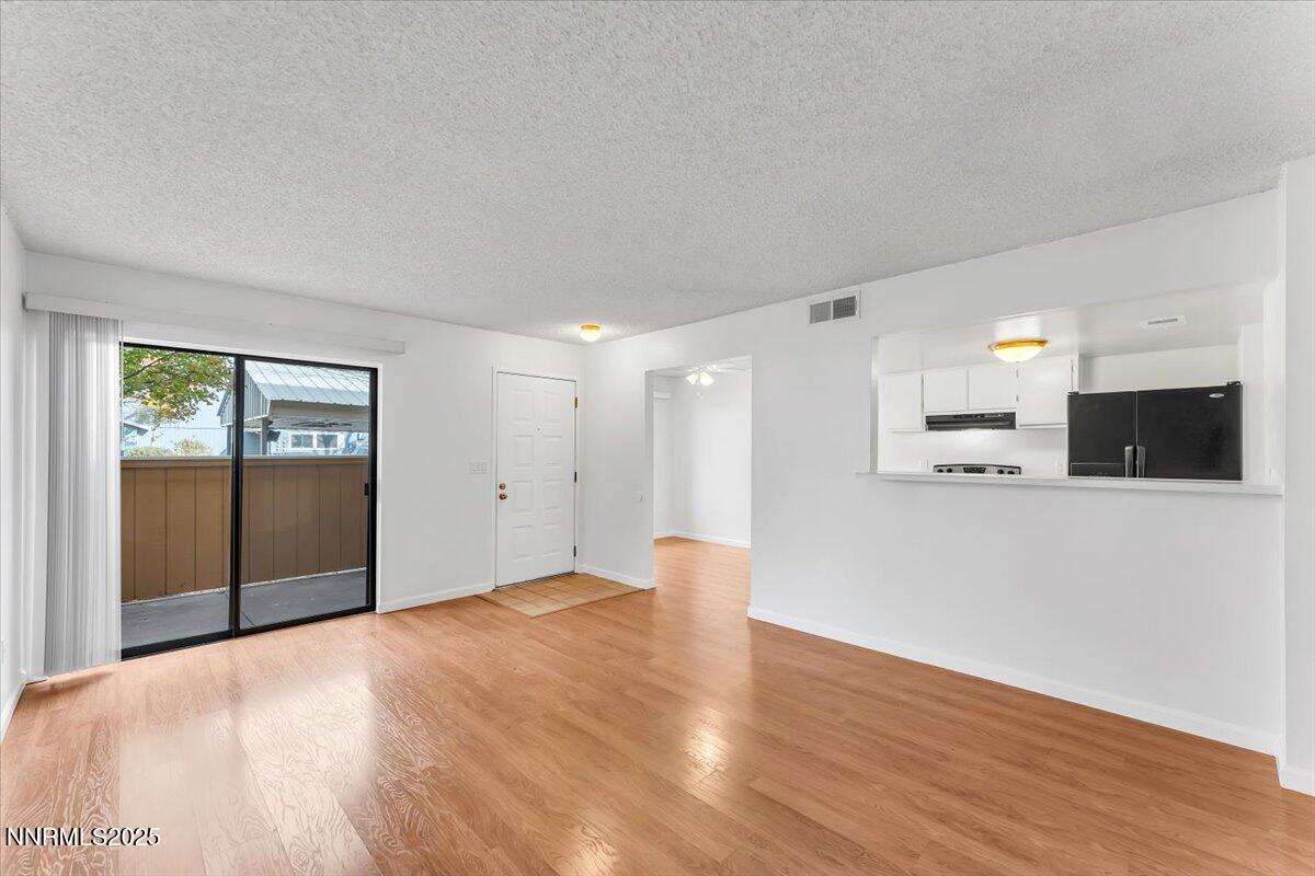 3230 Wedekind Road, Unit 64 Sparks, NV 89431 - Photo 7 of 28 a view of an empty room with wooden floor and a window