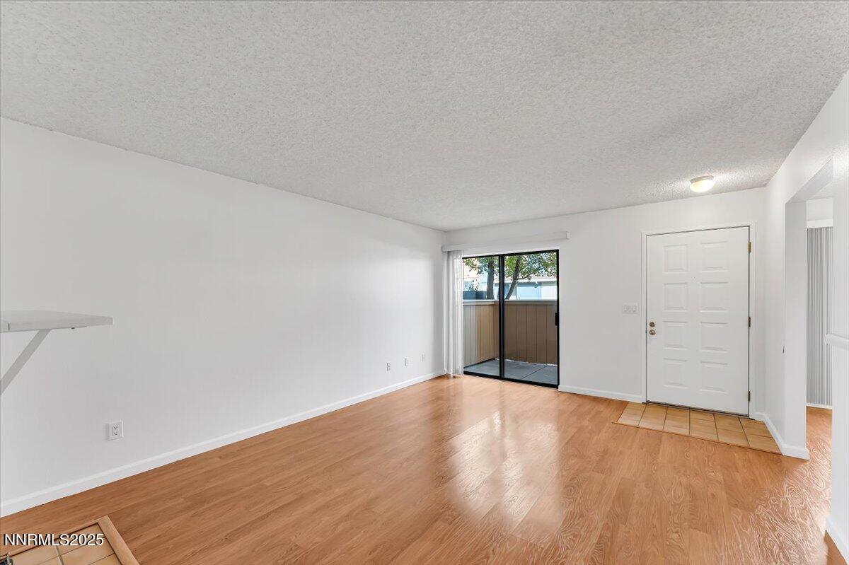 3230 Wedekind Road, Unit 64 Sparks, NV 89431 - Photo 8 of 28 a view of an empty room with wooden floor and a window