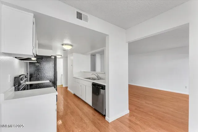 a kitchen with granite countertop a sink and a stove top oven