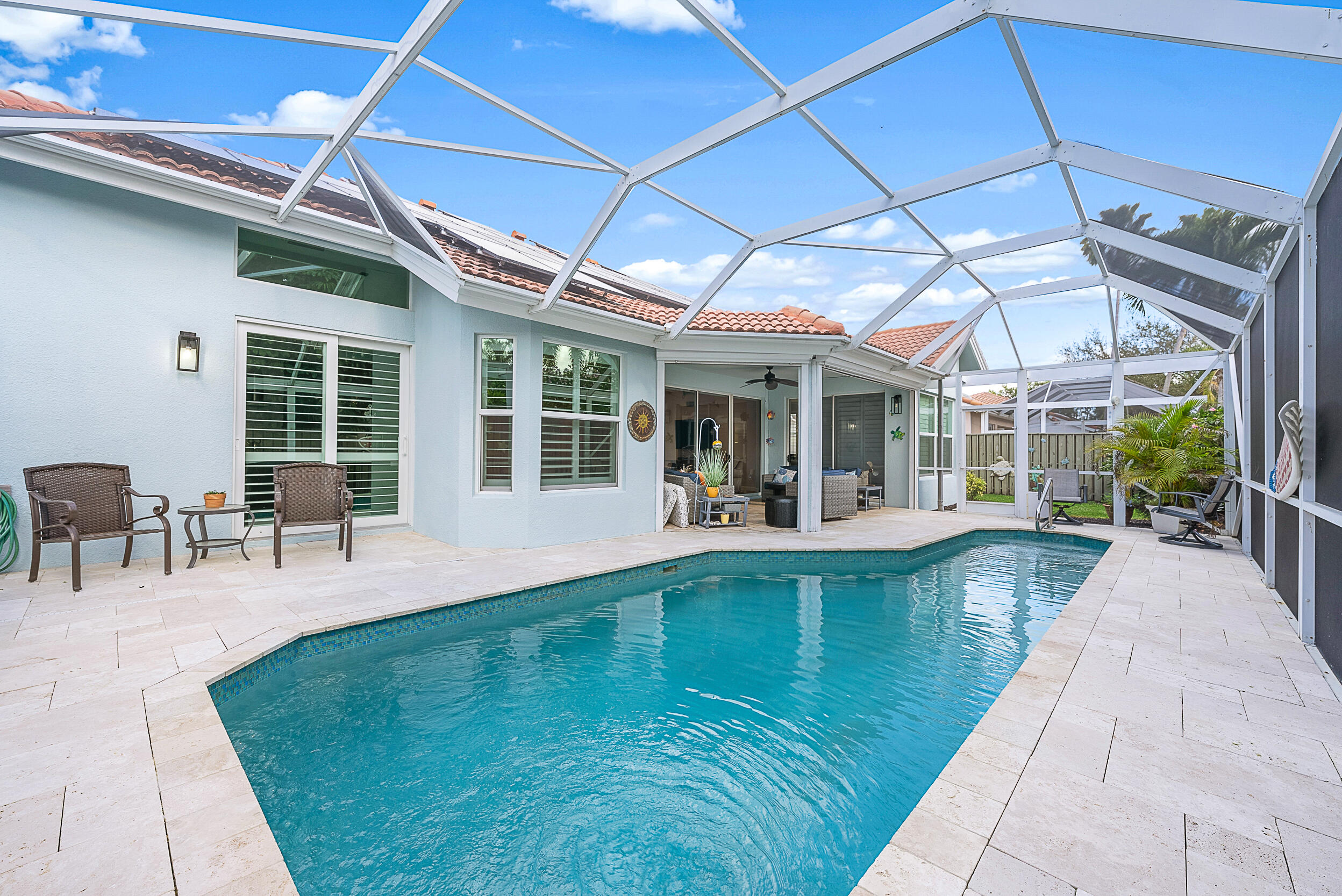 271 Eagleton Estates Boulevard Palm Beach Gardens, FL 33418 - Photo 1 of 37 a view of a swimming pool with outdoor seating