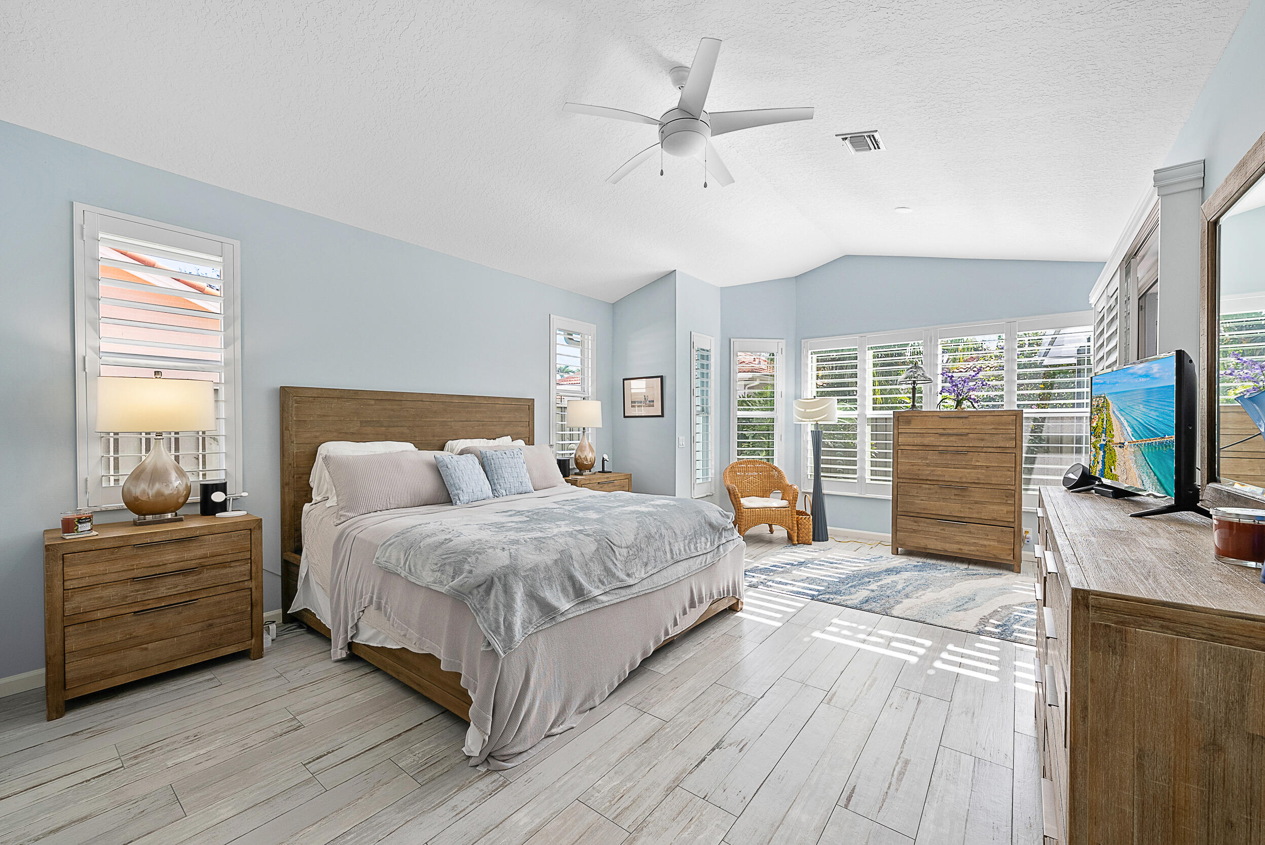 271 Eagleton Estates Boulevard Palm Beach Gardens, FL 33418 - Photo 12 of 37 a bedroom with a large bed a flat tv screen and a dresser