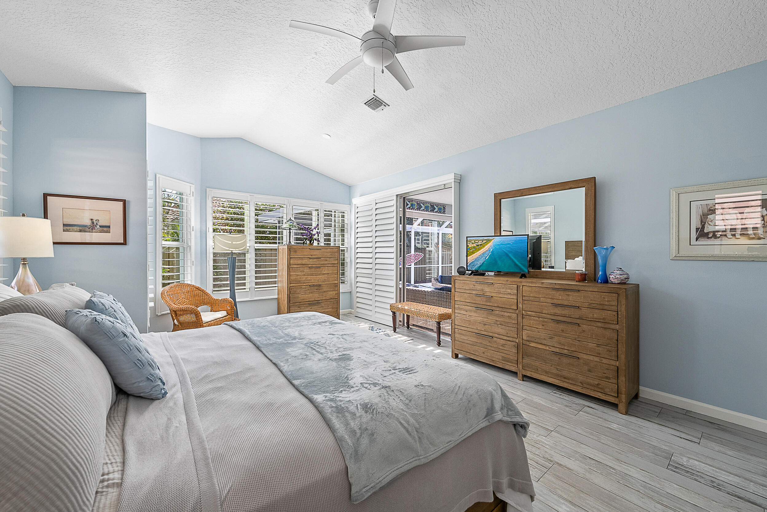 271 Eagleton Estates Boulevard Palm Beach Gardens, FL 33418 - Photo 13 of 37 a bedroom with a bed and wooden floor