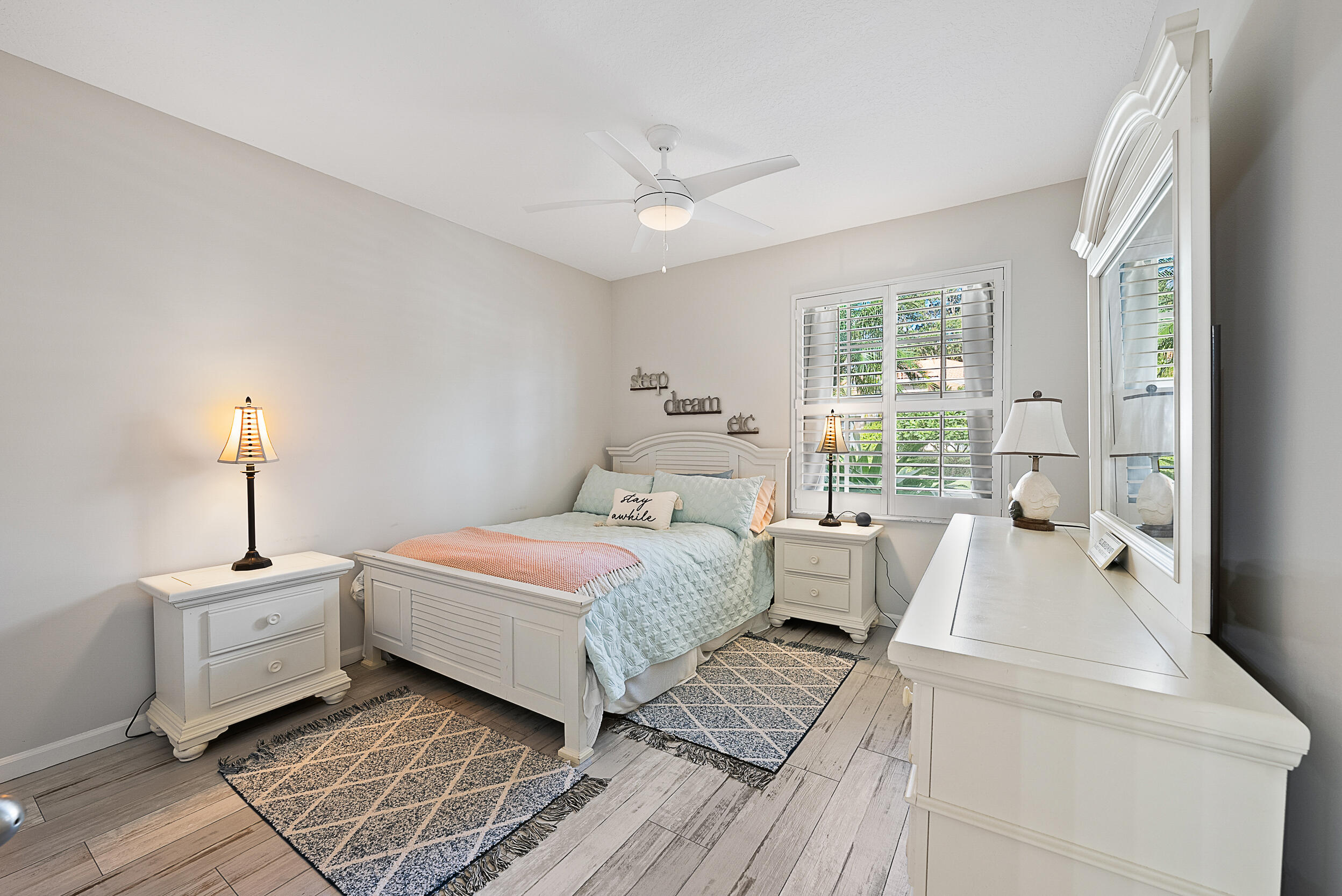 271 Eagleton Estates Boulevard Palm Beach Gardens, FL 33418 - Photo 18 of 37 a spacious bedroom with a bed and large windows