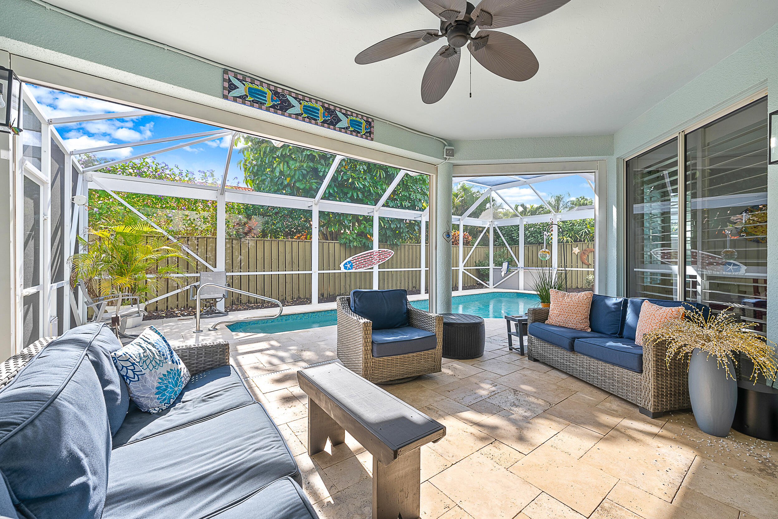 271 Eagleton Estates Boulevard Palm Beach Gardens, FL 33418 - Photo 2 of 37 a living room with furniture and a large window