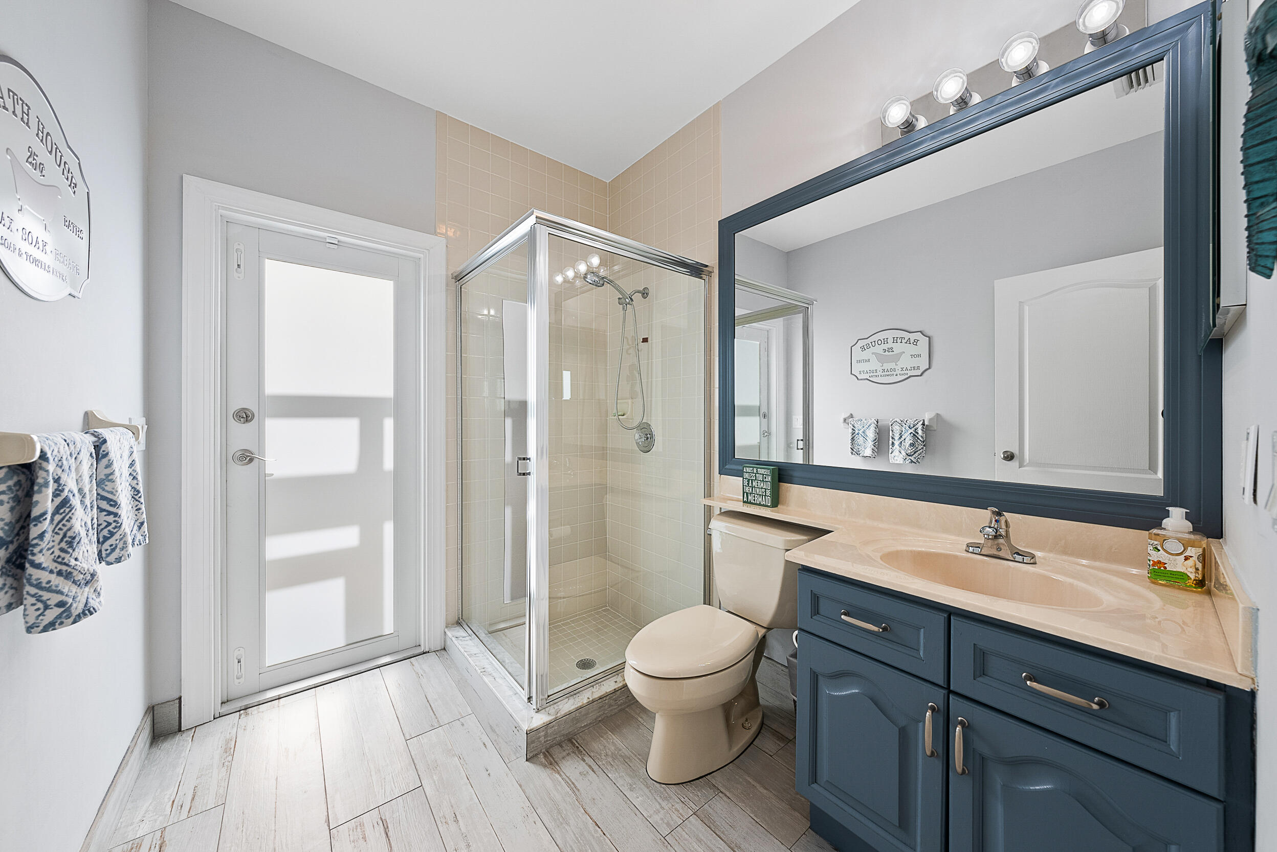 271 Eagleton Estates Boulevard Palm Beach Gardens, FL 33418 - Photo 23 of 37 a bathroom with a toilet a sink and a large mirror
