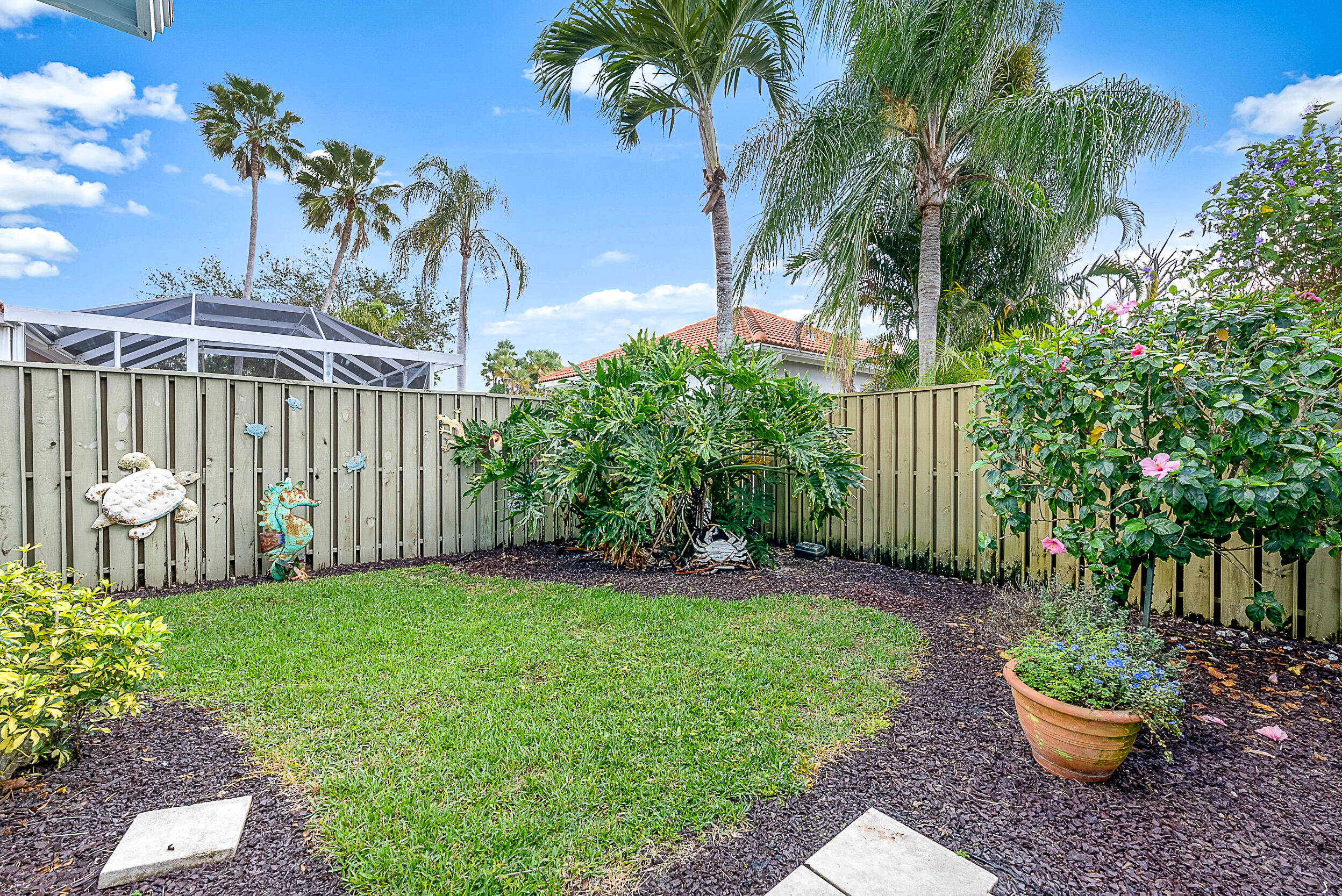 271 Eagleton Estates Boulevard Palm Beach Gardens, FL 33418 - Photo 26 of 37 a view of a backyard with a garden