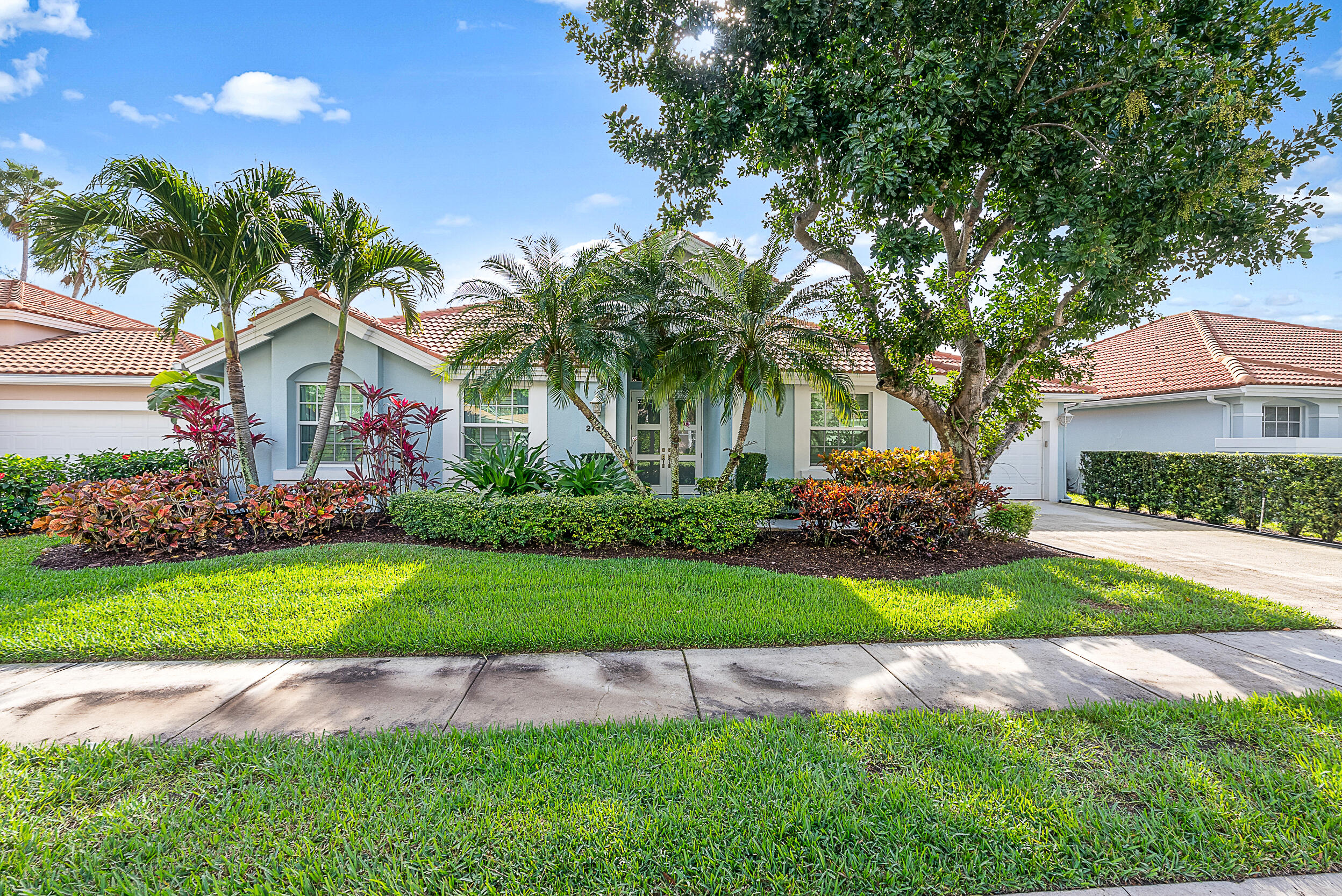 271 Eagleton Estates Boulevard Palm Beach Gardens, FL 33418 - Photo 27 of 37 a front view of a house with a yard and garage