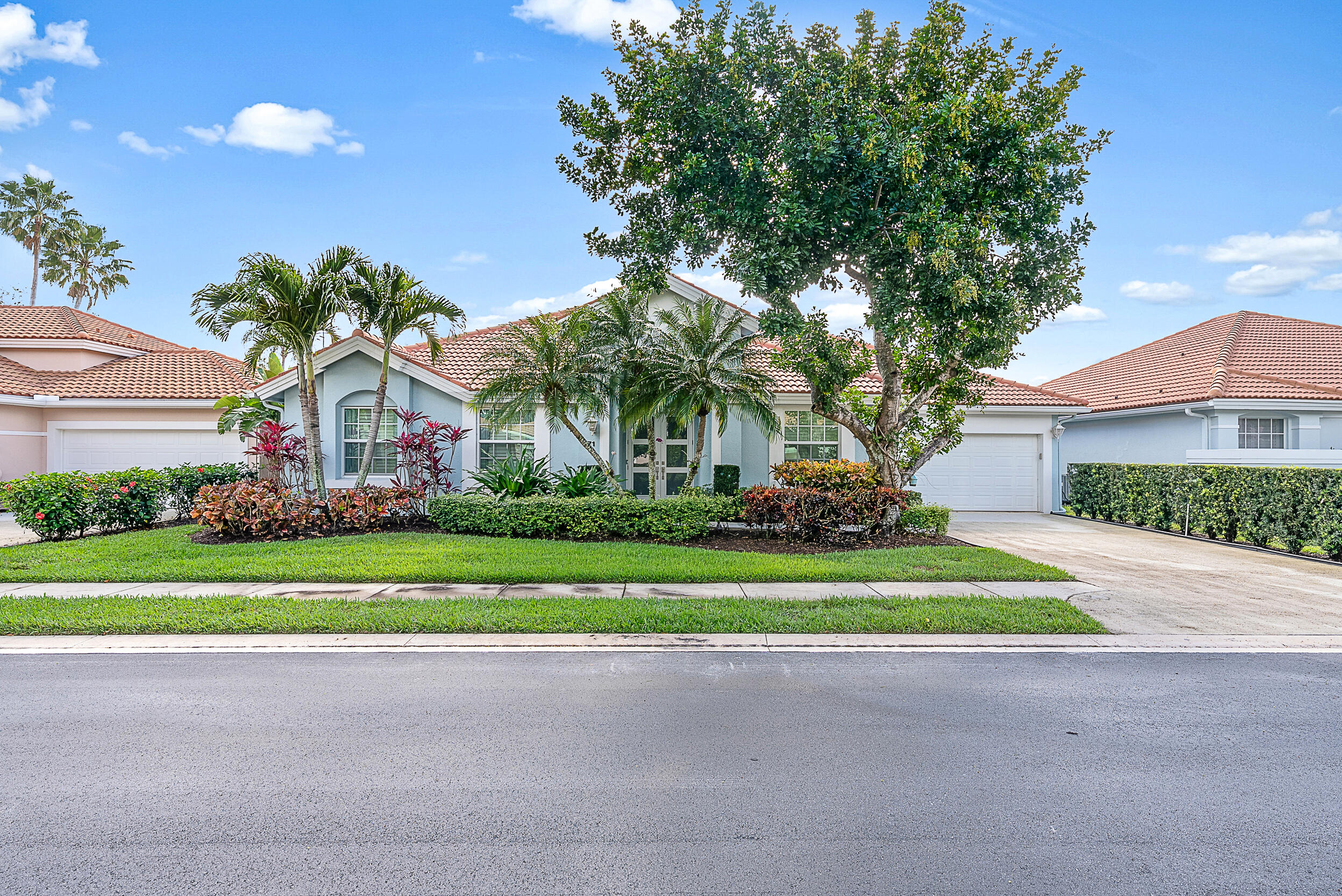 271 Eagleton Estates Boulevard Palm Beach Gardens, FL 33418 - Photo 28 of 37 a front view of a house with a yard and garage