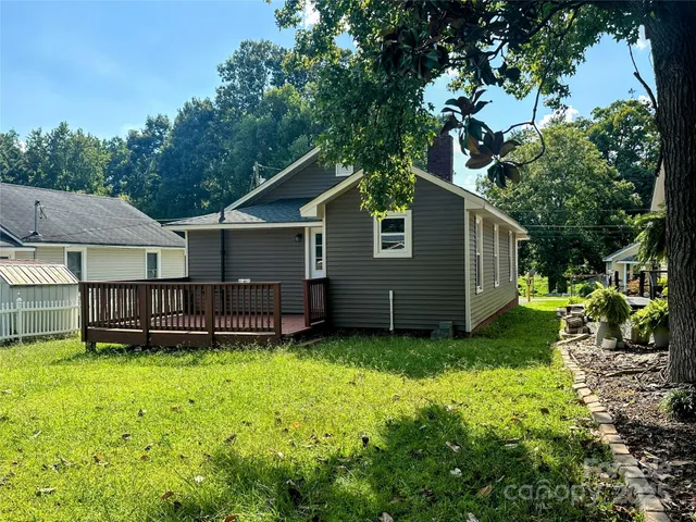 a view of a house with a yard and sitting area