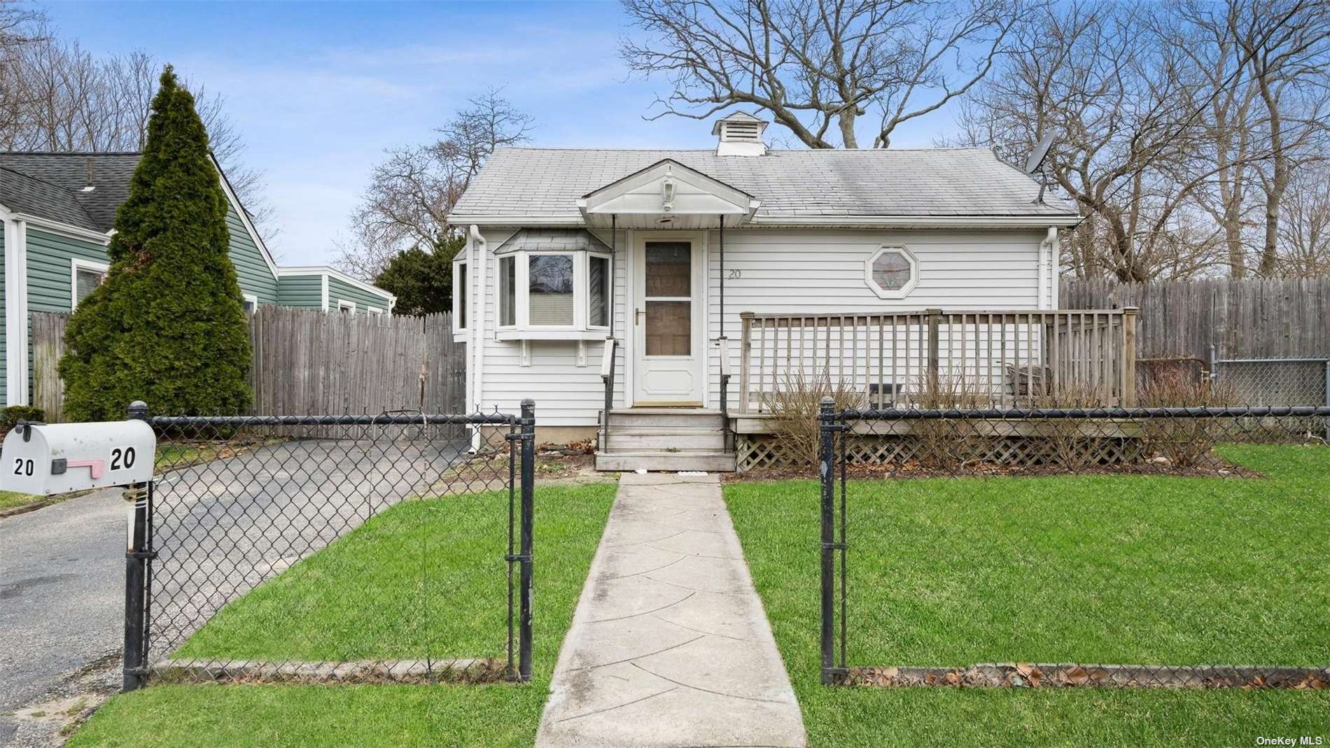 a view of a house with a garden and pathway