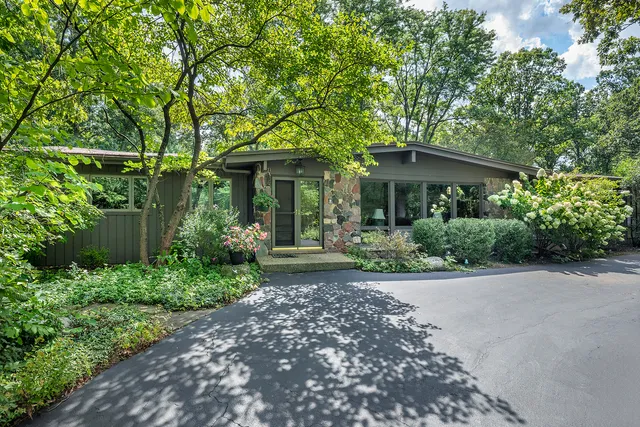 a front view of a house with garden