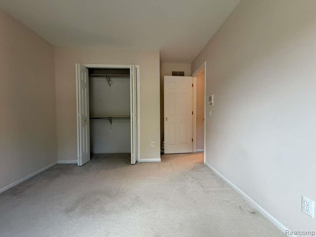 1154 Bluebird Drive Rochester, MI 48307 - Photo 22 of 34 Neutral-toned walls complement the light-colored carpeting