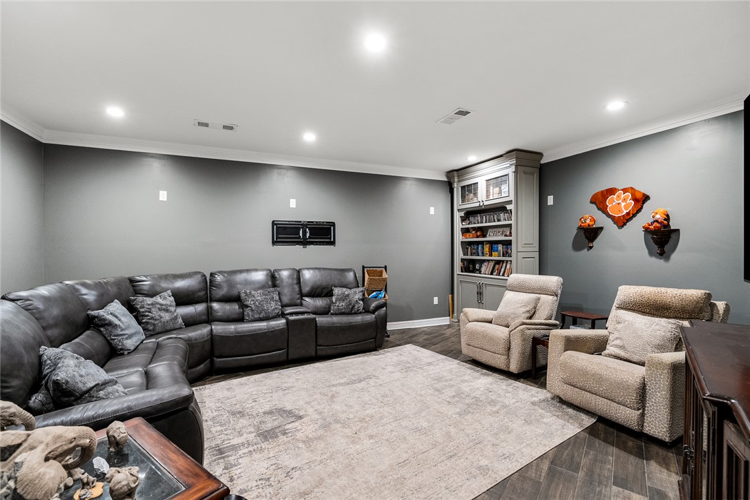 206 James Hare Road Anderson, SC 29626 - Photo 31 of 50 An inviting family room awaits with a spacious built-in bookcase and generous flooring underfoot.