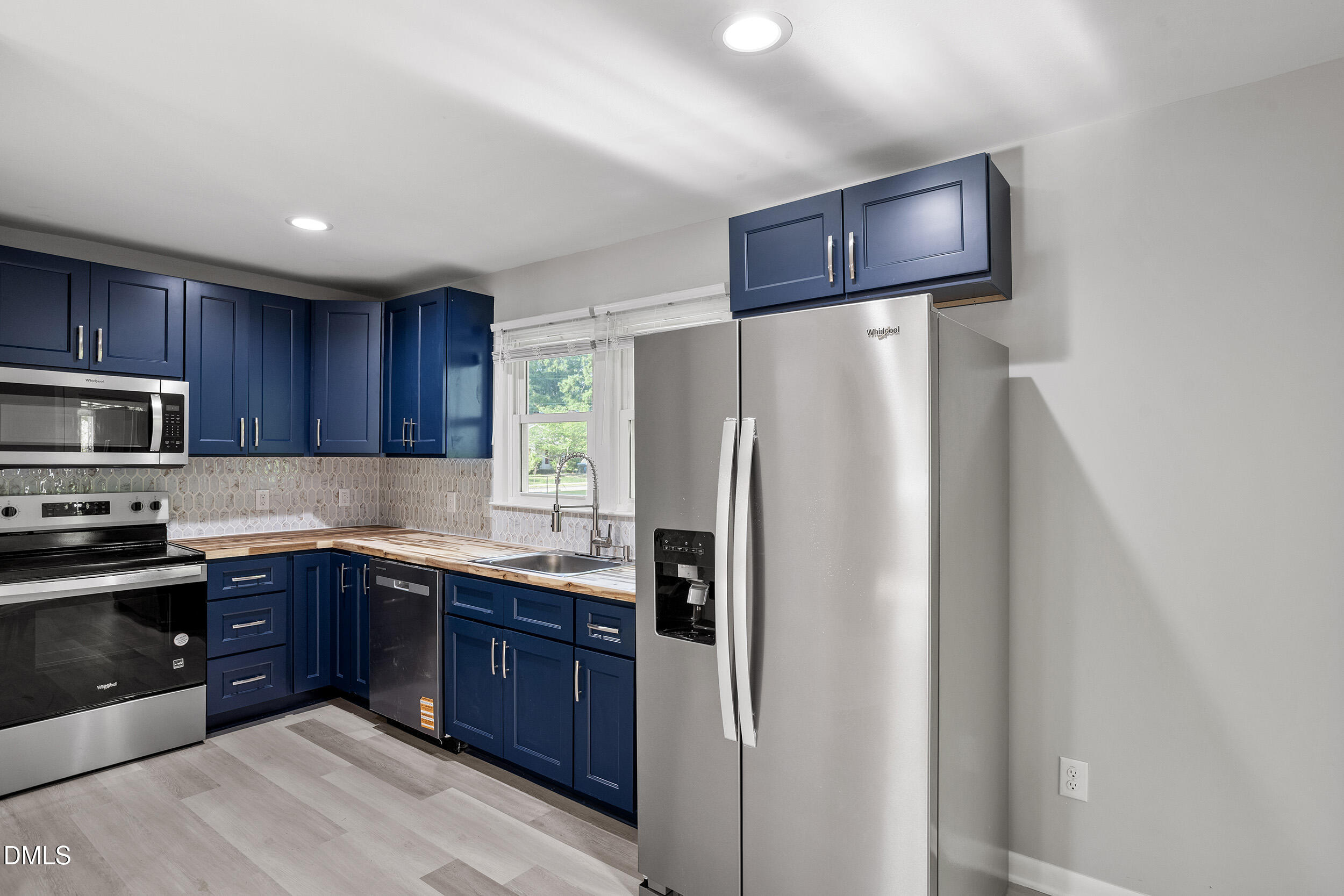 2414 Chapin Street Durham, NC 27707 - Photo 10 of 30 a kitchen with stainless steel appliances granite countertop a refrigerator and a stove top oven