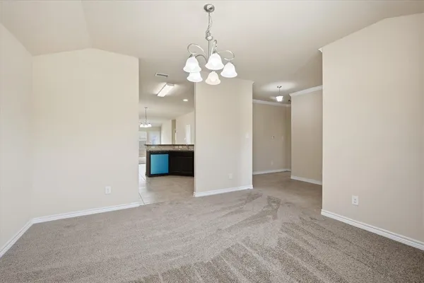 a view of an empty room with a kitchen