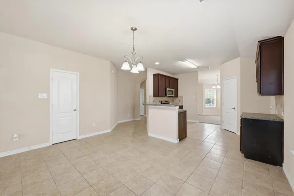 a view of a kitchen with microwave and cabinets
