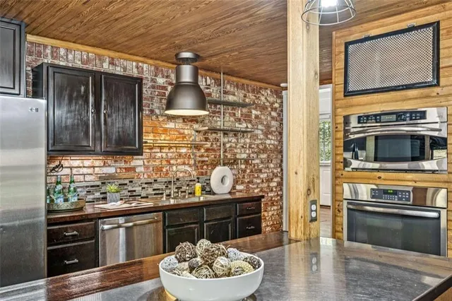 a kitchen view with granite countertop a stove a sink and a oven