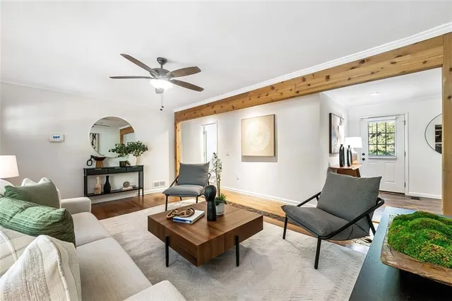 a living room with furniture a rug and a chandelier