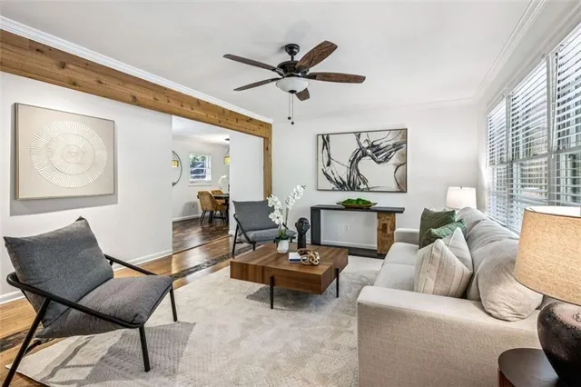 a living room with furniture and a ceiling fan