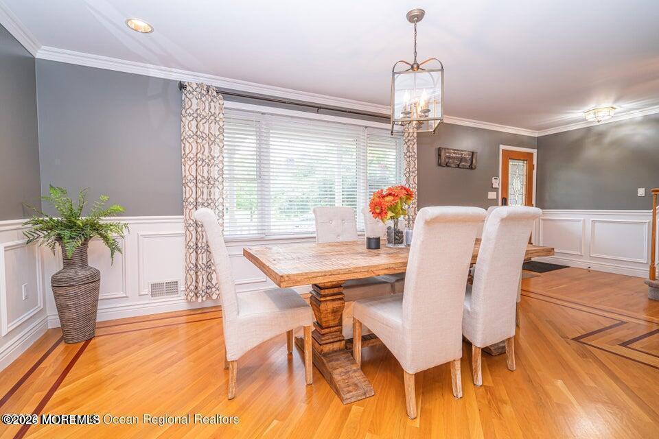 1 Kari Court Jackson, NJ 08527 - Photo 12 of 66 a dining room with furniture a chandelier and wooden floor