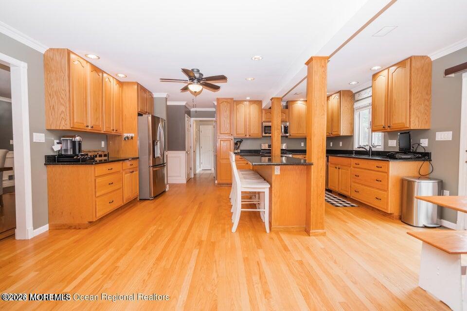 1 Kari Court Jackson, NJ 08527 - Photo 25 of 66 a kitchen with stainless steel appliances kitchen island granite countertop a table chairs and a stove top oven